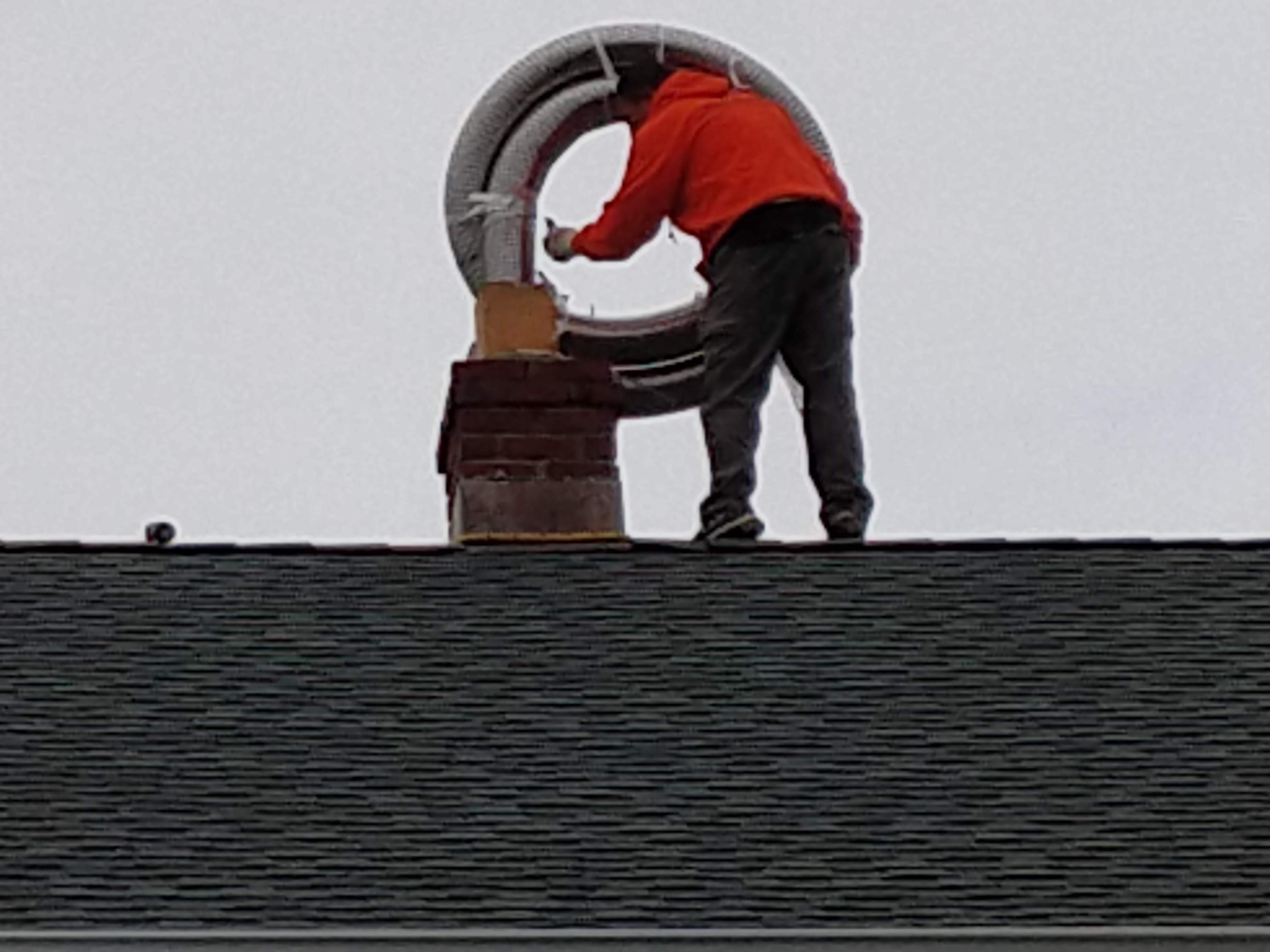 Flexible stainless chimney liner being installed in Massapequa Park, New York